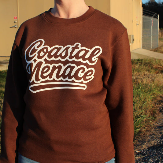 woman wearing coastal menace retro script brown crewneck front view