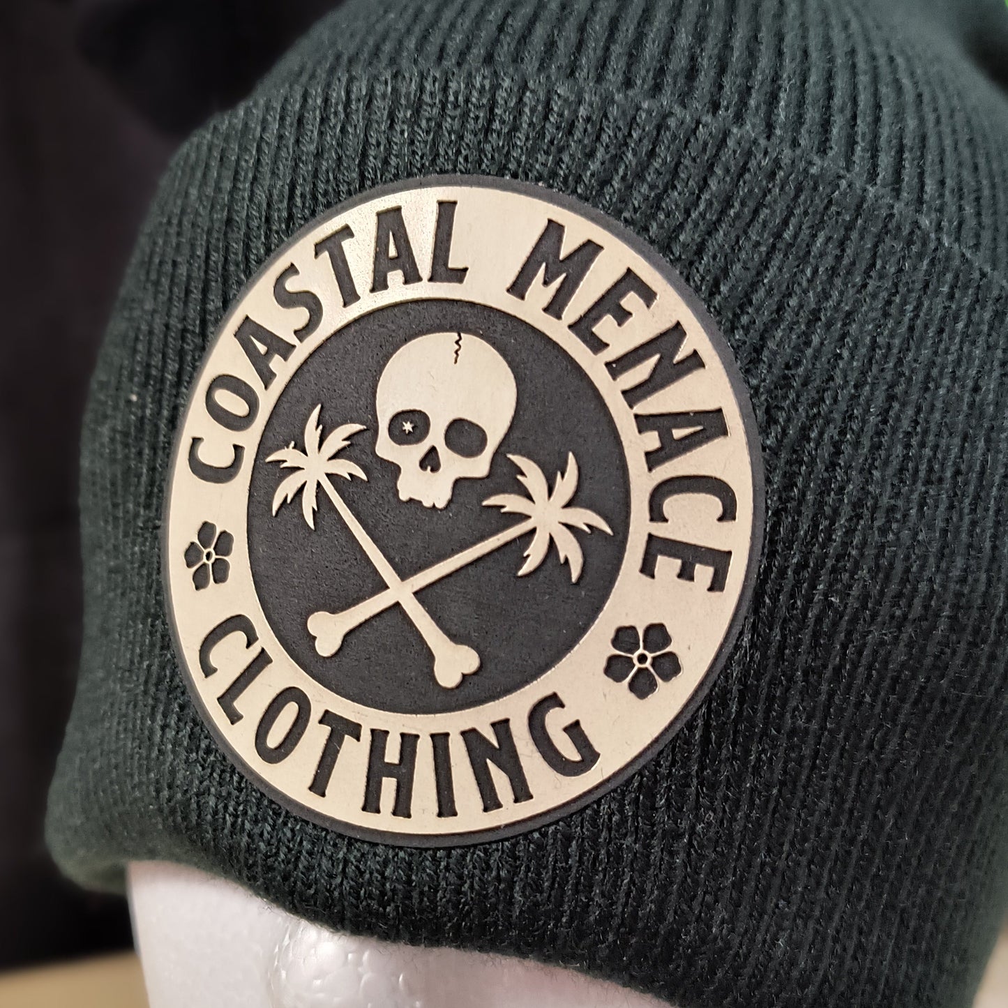 Closeup of black Base Threat beanie patch