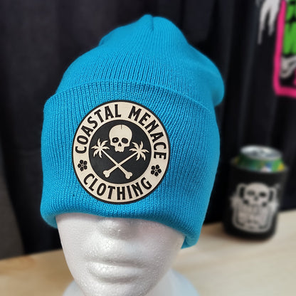Neon blue Coastal Menace Base Threat beanie with skull and palms patch