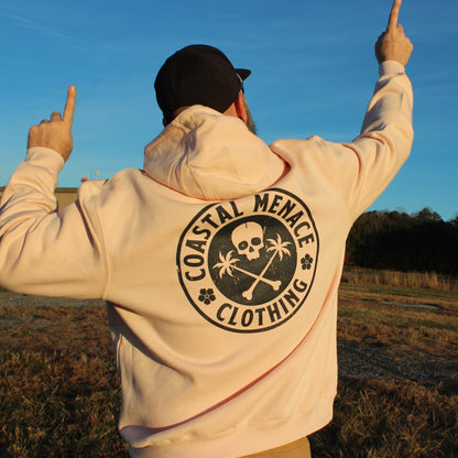 Back view of the Base Threat pink hoodie worn by male model pointing upward.