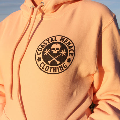 Detailed close-up of the Base Threat pink hoodie front chest print.