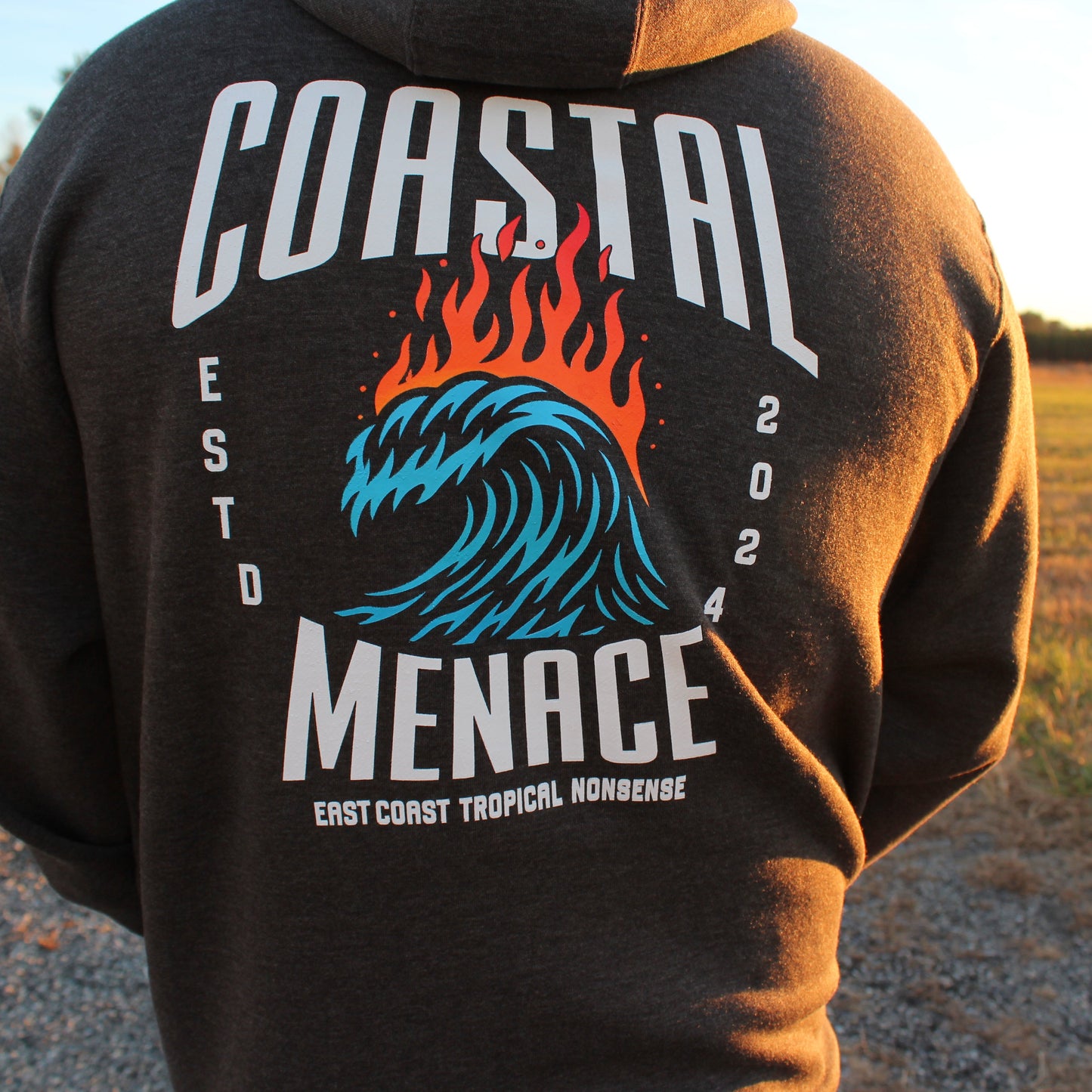 Back view of the Hot Breaker charcoal zip hoodie as male model walks outdoors.