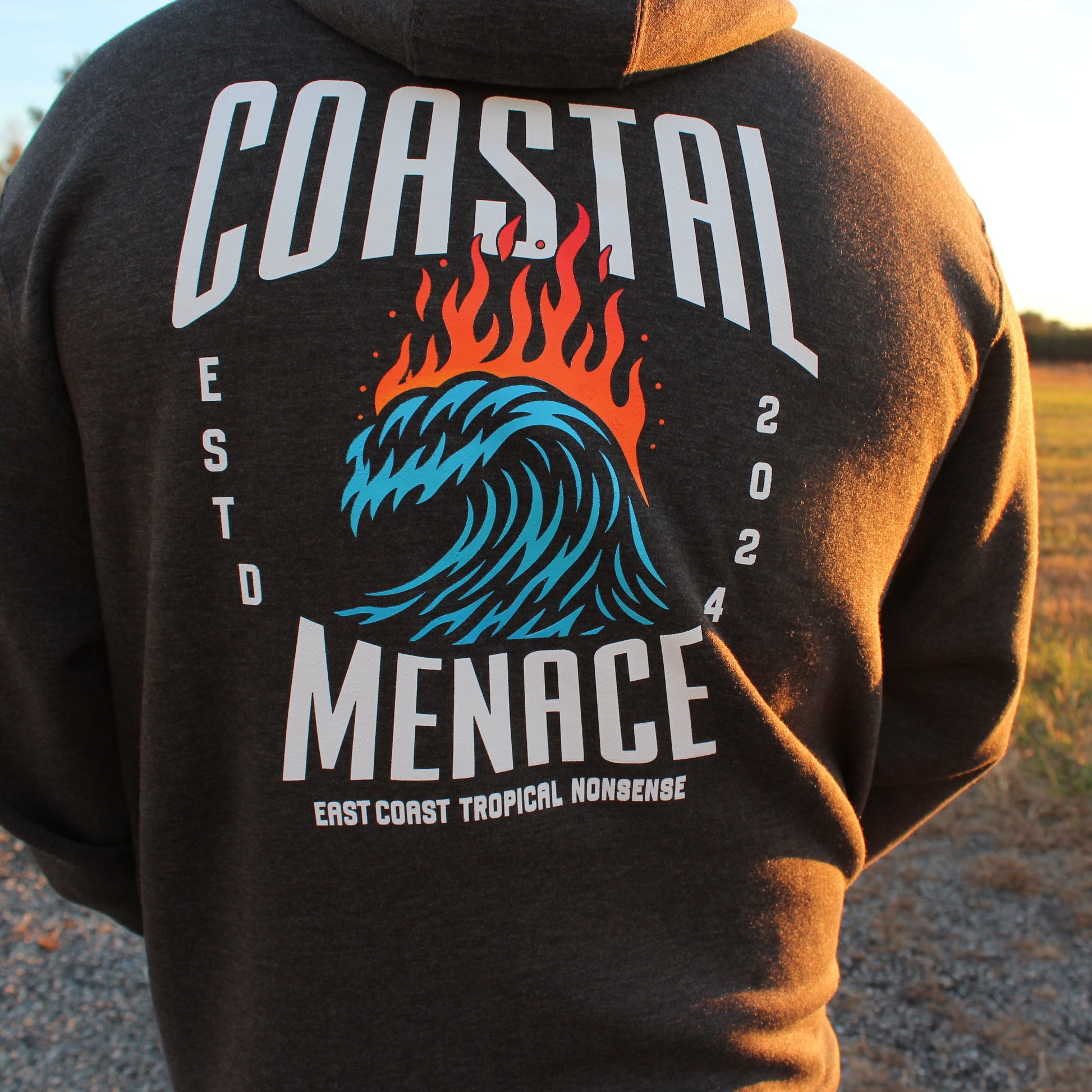 Back view of the Hot Breaker charcoal zip hoodie as male model walks outdoors.