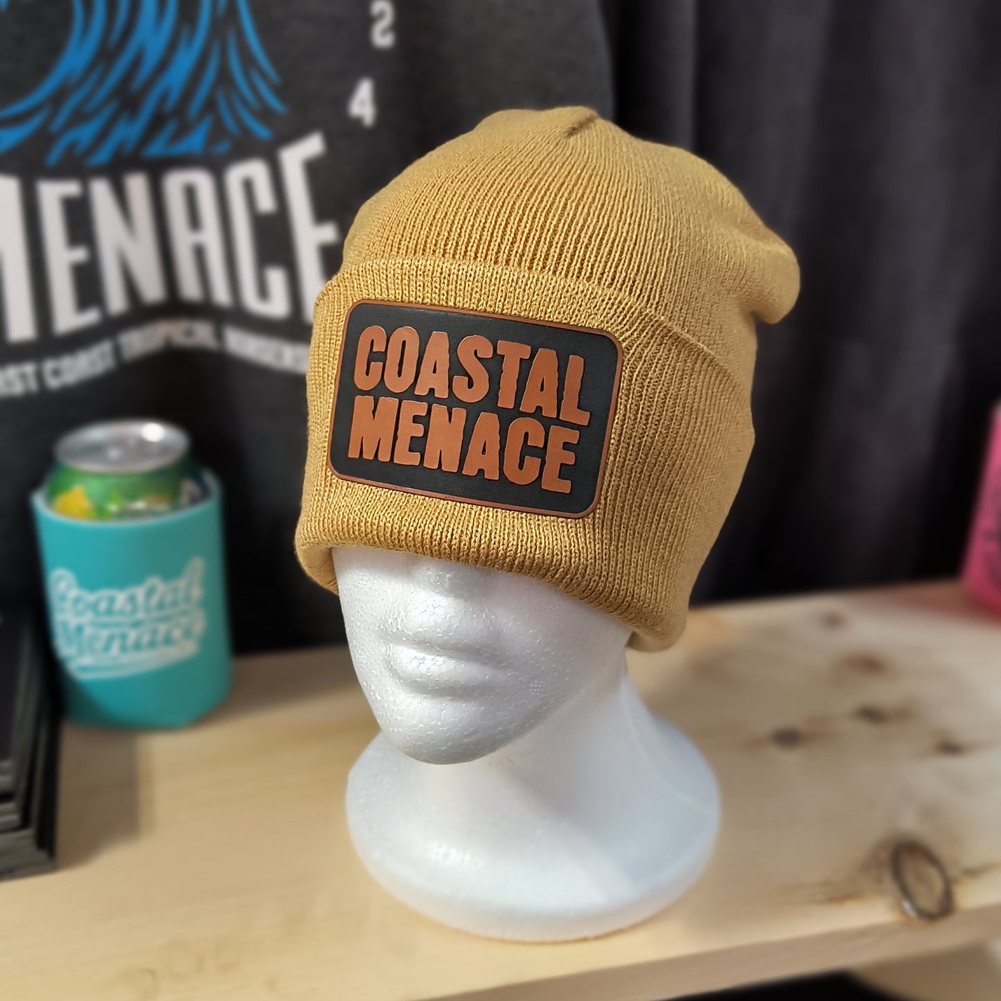 tan knit beanie with brown Coastal Menace OG patch on the cuff
