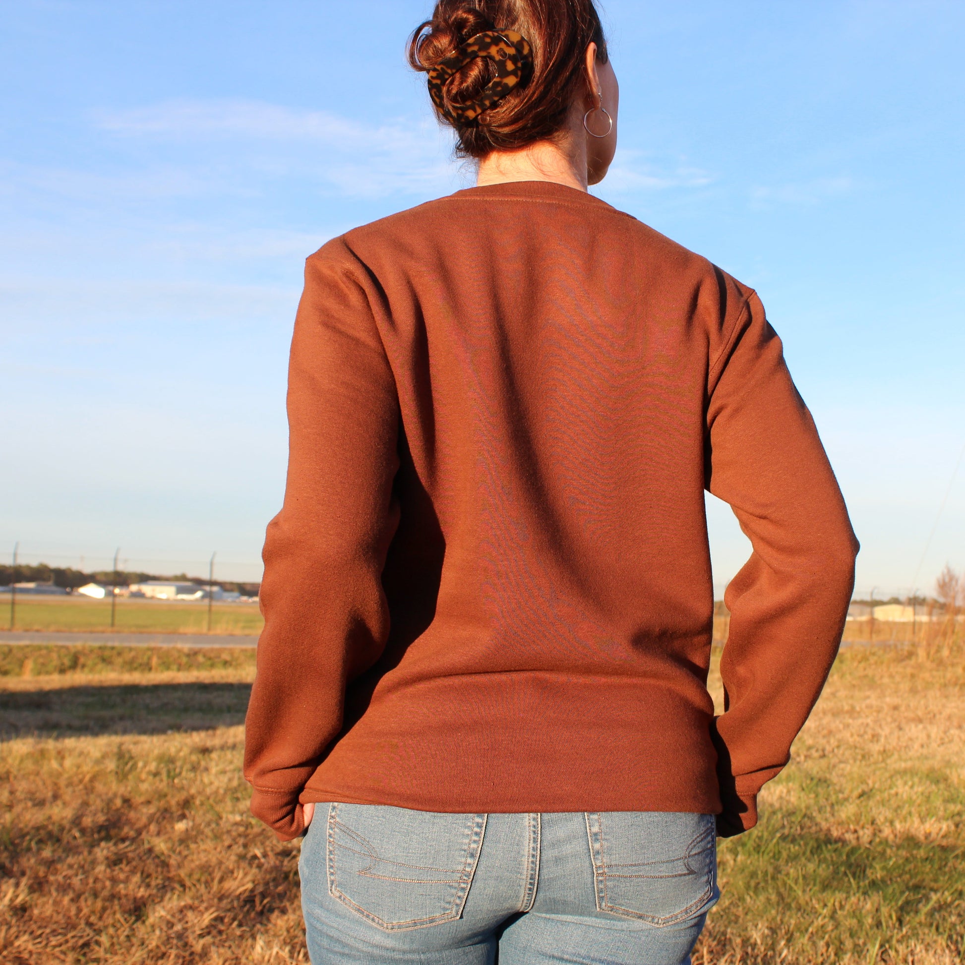 woman wearing coastal menace retro script crewneck showing back