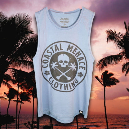 Light blue tank top with large Coastal Menace skull-and-palms circle graphic on the front, displayed against a tropical sunset background