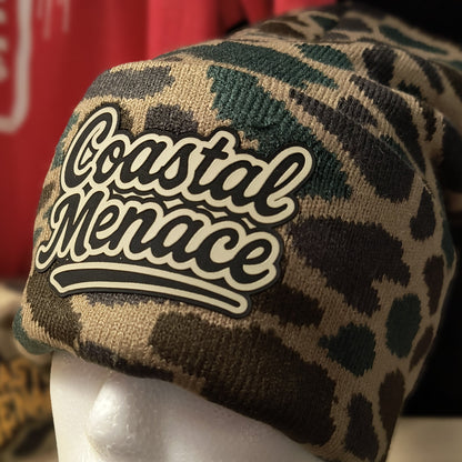close up of duck camo beanie with Coastal Menace retro script patch